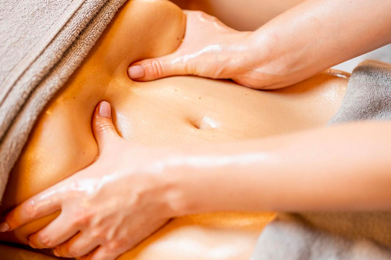 A woman receiving a Renata França Brazilian Lymphatic Drainage Massage to eliminate excess of fluid and size