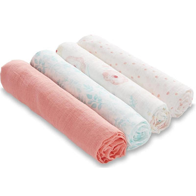 Four rolled muslin swaddle blankets in pastel colors and floral patterns, featuring pink, mint, and white designs.