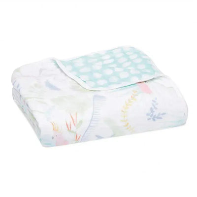 Muslin blanket by Aden + Anais, featuring a tropical print with pastel colors and a mint green polka dot border.