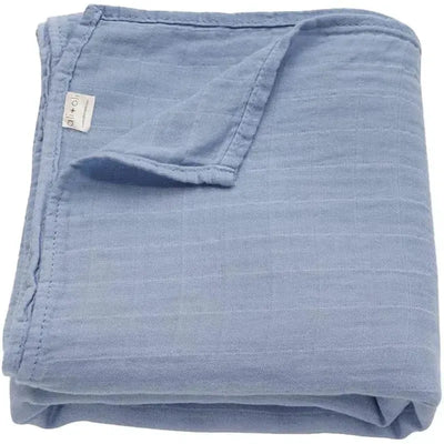 Soft, folded muslin swaddle blanket in Dream Blue, featuring a wrinkled texture and ali + oli label.