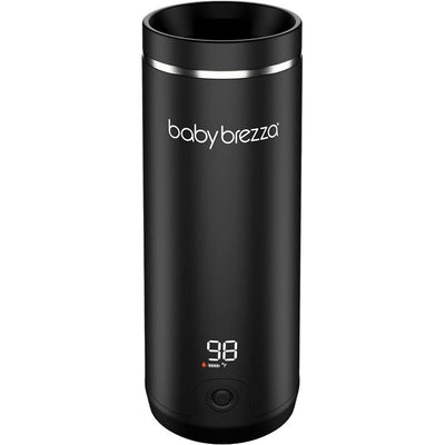 Portable Baby Brezza bottle warmer in black with a digital display showing a temperature of 98°F.