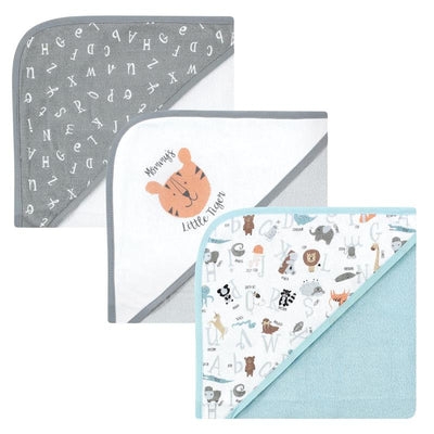 Three hooded baby towels featuring playful designs: one with alphabet letters, another with a tiger graphic, and a third with animals.