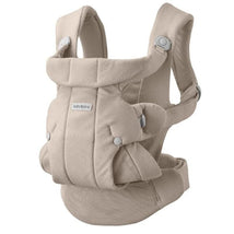 Babybjörn Baby Carrier Hold in sand gray, featuring padded shoulder straps and adjustable buckles for comfortable carrying.