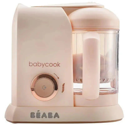 Beaba Babycook Solo 4 in 1 baby food maker in rose gold with a transparent bowl and control dial.