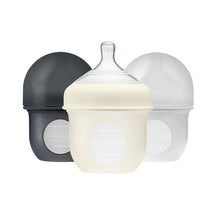 Three 4 oz. baby bottles from Boon, featuring gray and clear designs with easy-grip bodies and measurement markings.