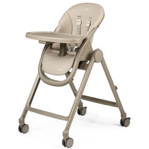 Peg Siesta High Chair in Space Sand color, featuring a padded seat, safety harness, and a removable tray on wheels.