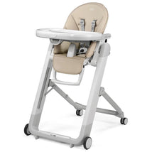 Folding high chair and recliner in beige with a safety harness, adjustable tray, and wheels for mobility.