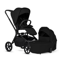 Silver Cross Breez Compact Stroller in Onyx with a matching folding bassinet, both in sleek black design.