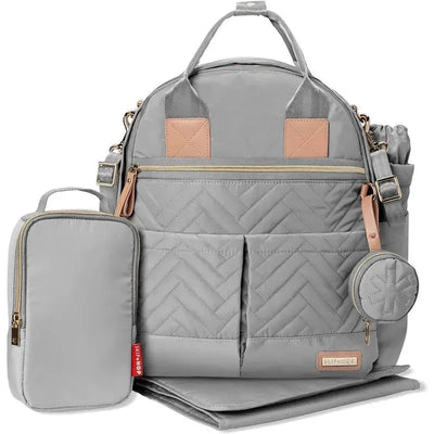 Skip Hop Suite Diaper Bag Backpack Set in Dove gray, featuring a quilted design, multiple pockets, a changing mat, and a removable pouch.