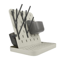 Tomy Groove Drying Rack with a slotted design, featuring gray drying rods and containers, designed for drying baby bottles and accessories.