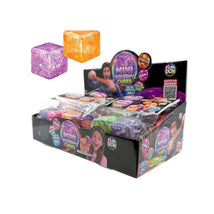 Two colorful, squishy mini cubes in assorted colors displayed above a box of Fun Doh Mini Squishy Cubes, promoting their stretchable and squishy qualities.