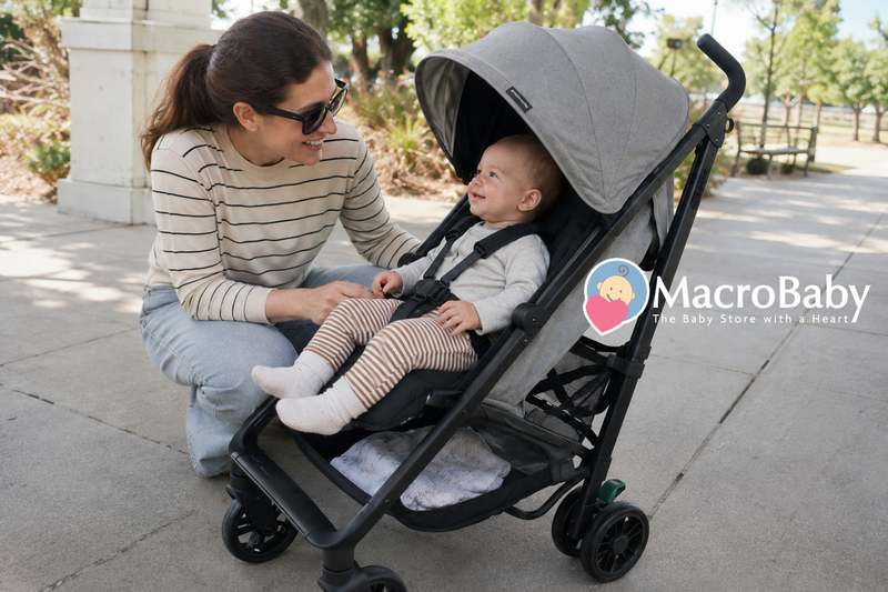 Baby in a stroller with mom at the park.