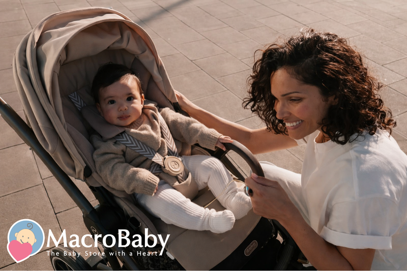 Mom smiling with baby in beige stroller outdoors, cozy knit outfit, perfect for baby gear shopping