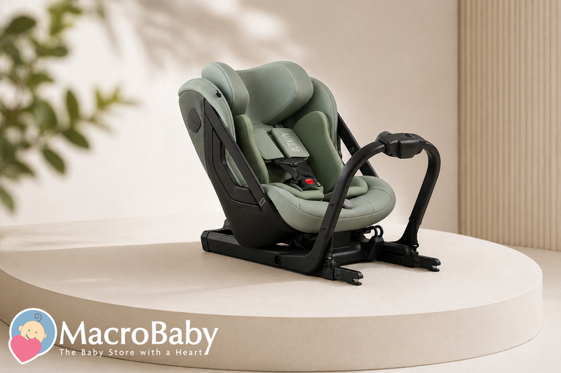 Modern green baby car seat with black frame on display pedestal, ideal for infant safety and comfort.