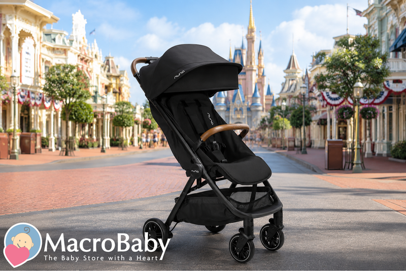 Black Nuna stroller on Disney street, perfect for baby travel and theme park adventures.