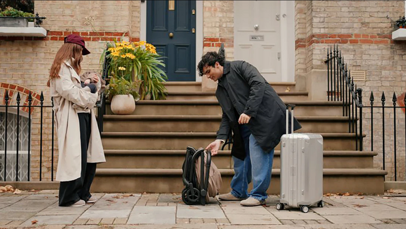 Parents with baby stroller and luggage outside home, ready for travel with baby gear