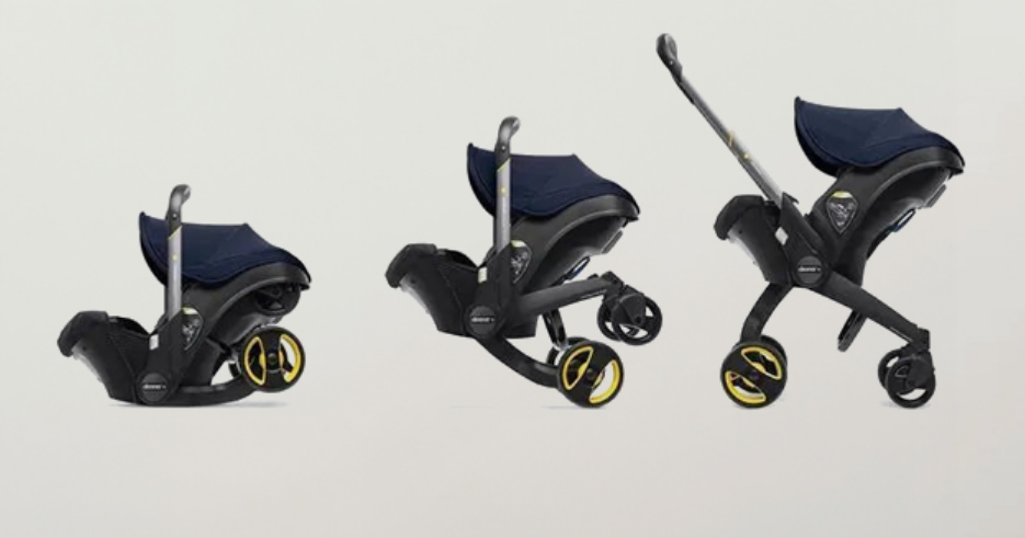 Convertible baby stroller with car seat, navy canopy, and yellow-accent wheels for easy travel