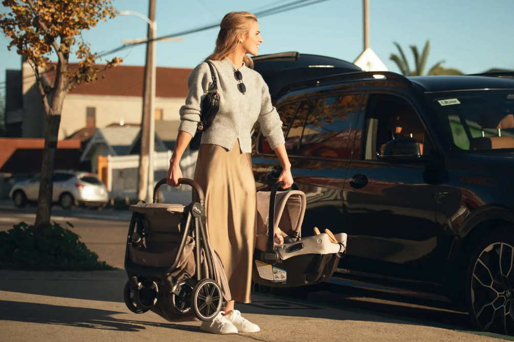 Mom with baby stroller and car seat near SUV, perfect for on-the-go parenting