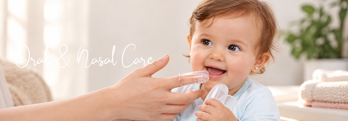 A caregiver using a baby finger toothbrush for oral care on a smiling infant.
