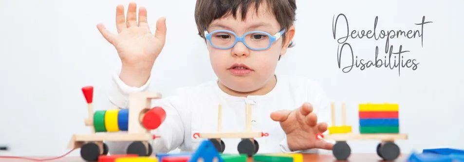 Child with glasses playing with colorful wooden train toys for developmental learning