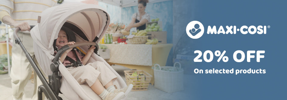 Happy baby in Maxi-Cosi stroller at outdoor market, 20% off selected products