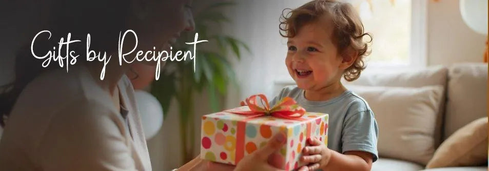 Happy toddler receiving colorful gift box with polka dots, perfect for baby gifts and celebrations