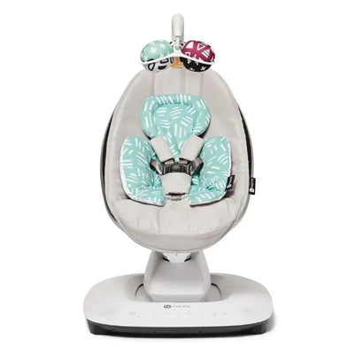 Reversible newborn insert for a 4 Moms swing, featuring mint green fabric with abstract patterns and safety harness.