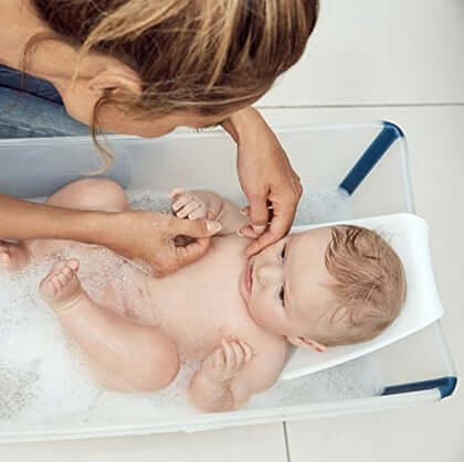Mom Bathing Baby on a Stokke Flexi Bath Banner