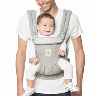 Daddy holding baby on a carrier. Baby carrier for babies