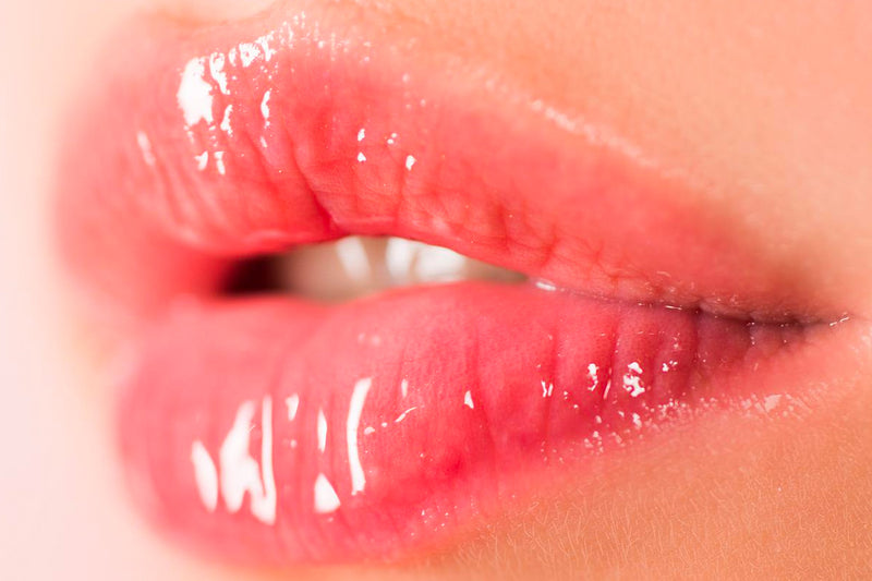 A woman with full, plump and hydrated lips after receiving a HydraGloss procedure.