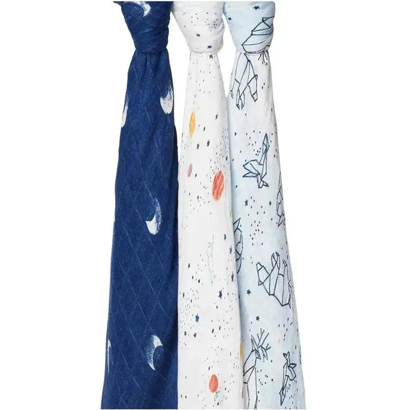 Aden + Anais 3-pack swaddles featuring a navy moon pattern, a white starry design, and a light blue paper crane motif.
