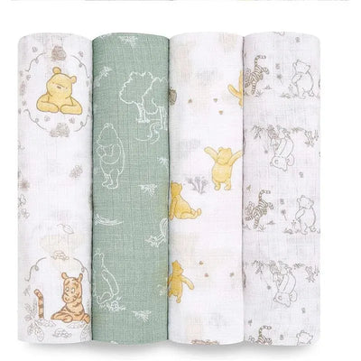 Aden+Anais muslin swaddles featuring Winnie the Pooh and friends in soft, playful colors and patterns.