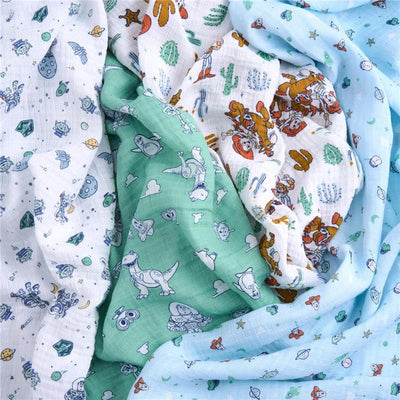 Aden + Anais 4-pack muslin swaddle blankets featuring Toy Story characters in various colors and patterns, perfect for infants.