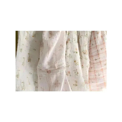 Four muslin swaddle blankets by Aden + Anais, featuring floral and pastel patterns in soft, lightweight fabric.