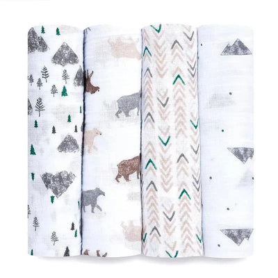 Four muslin swaddles in a variety of patterns, including trees, bears, and geometric designs, from Aden + Anais.