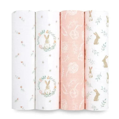Four muslin swaddles featuring pastel colors and bunny designs, including floral patterns and a wreath motif.