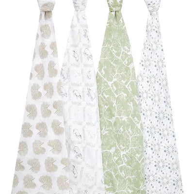Four muslin swaddles from Aden + Anais in various patterns: leaves, animals, trees, and floral designs.
