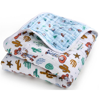 Cotton muslin blanket featuring Toy Story characters Woody and friends, with a playful western-themed design and blue backing.