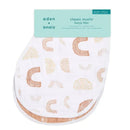 Aden + Anais classic muslin burpy bibs featuring patterns of arches and dots, made from 100% cotton, packaged in a light teal label.