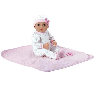 Adoption baby doll named Cherish, wearing a floral onesie and pink hat, sitting on a soft pink blanket with a pacifier.
