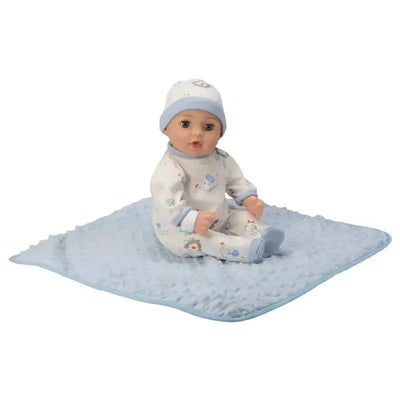 Adora Adoption Baby, Handsome doll seated on a soft blue blanket, dressed in a patterned outfit and matching hat.
