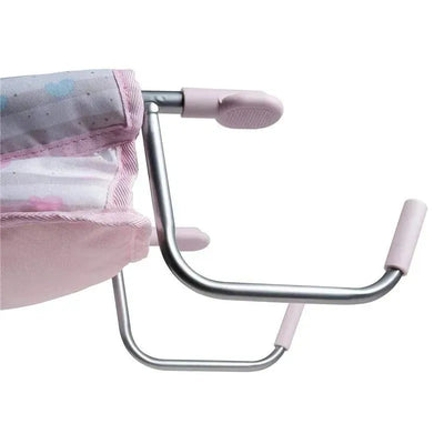 Pastel pink feeding seat for dolls, featuring a sturdy metal frame and soft fabric, designed for imaginative play.