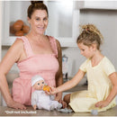 A woman and a girl play with a baby doll, using a magic feeding set. The girl feeds the doll with an orange bottle.