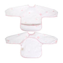 Long sleeve smock bib in pink with white background and flower patterns, featuring a pocket for catching spills.