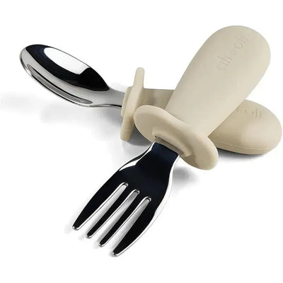 Khaki spoon and fork learning set for toddlers, featuring soft grip handles and stainless steel ends, designed for easy use.
