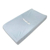 Blue fitted contoured changing pad cover made of soft minky dot fabric, featuring a safety strap for secure use.