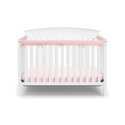 Pink and white side crib rail covers with bows, designed to protect infants in a white crib with a pink mattress.