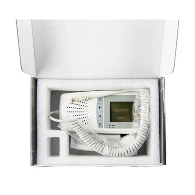 Fetal monitor Doppler device, showing the monitor screen and control buttons, displayed inside its protective packaging.