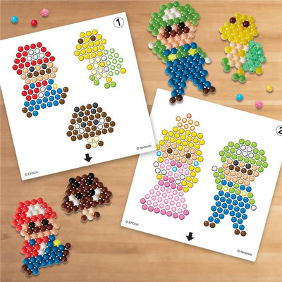 Aquabeads Super Mario Character Set showcasing colorful bead templates for Mario, Luigi, Princess Peach, and a mushroom.
