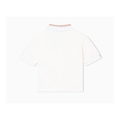 Short sleeve white polo shirt for baby boys with a textured collar.